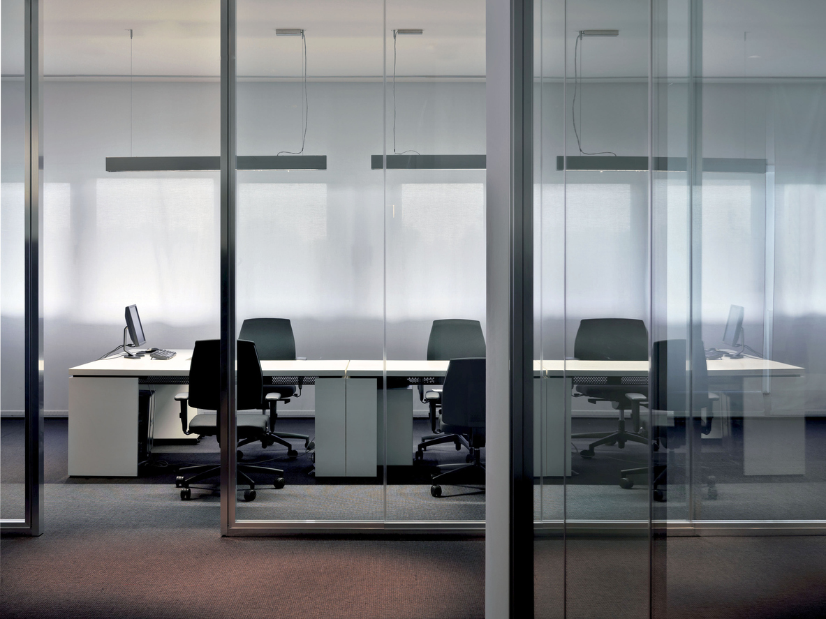 A spacious office with transparent walls and comfortable seating arrangements.
on skopecleaning.com